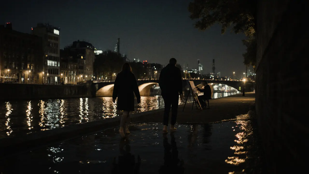 A man and woman walk barefoot along the Spree River at night, their reflections in the water, Berlin’s skyline glowing behind them in silence.