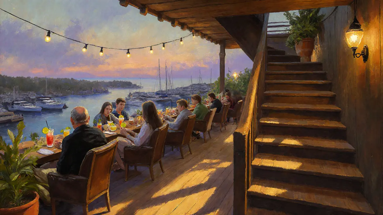 Hidden rooftop bar Le Plongeoir at dusk with guests sipping cocktails above Monaco&#039;s port.