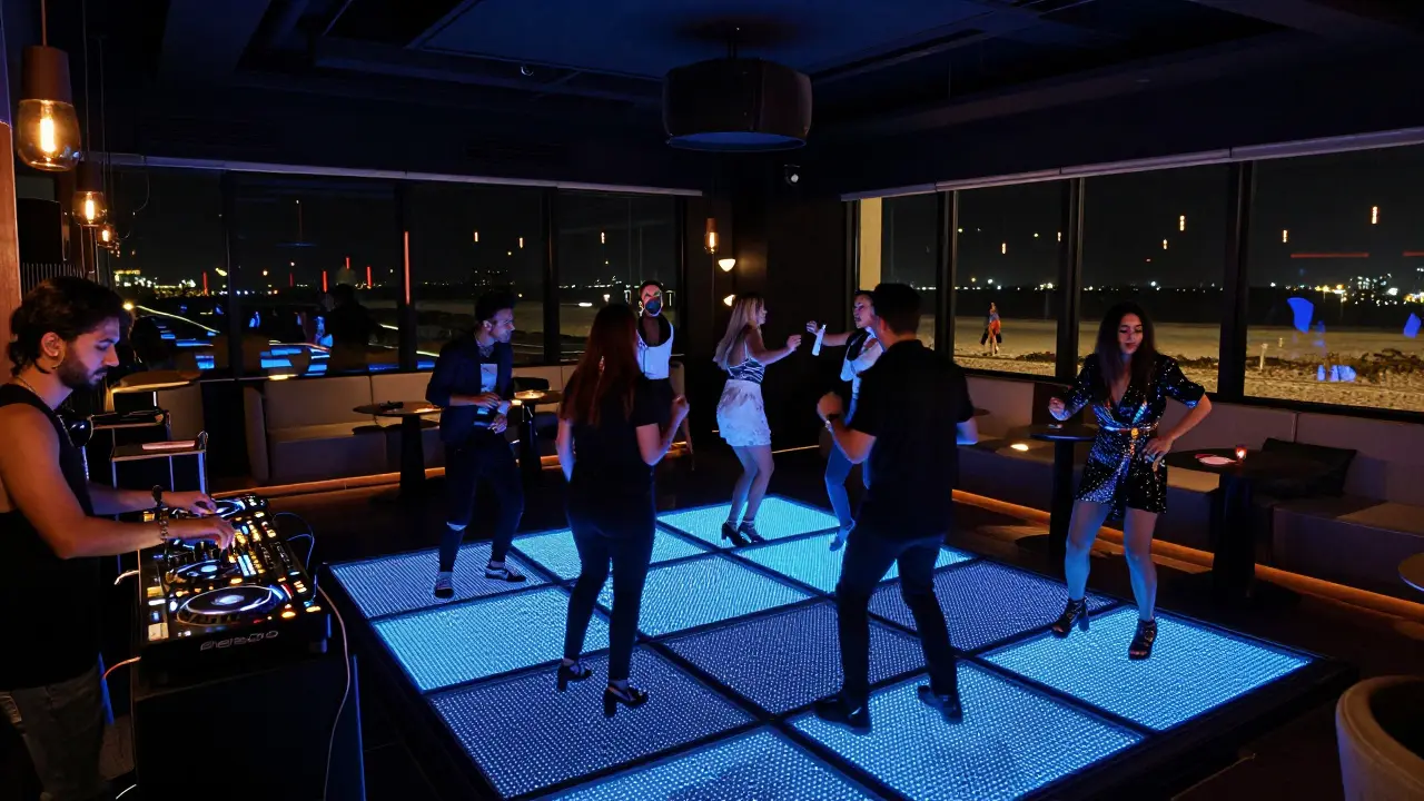 Crowd dancing at a modern nightclub in Abu Dhabi under colorful LED lights with a beachfront view.