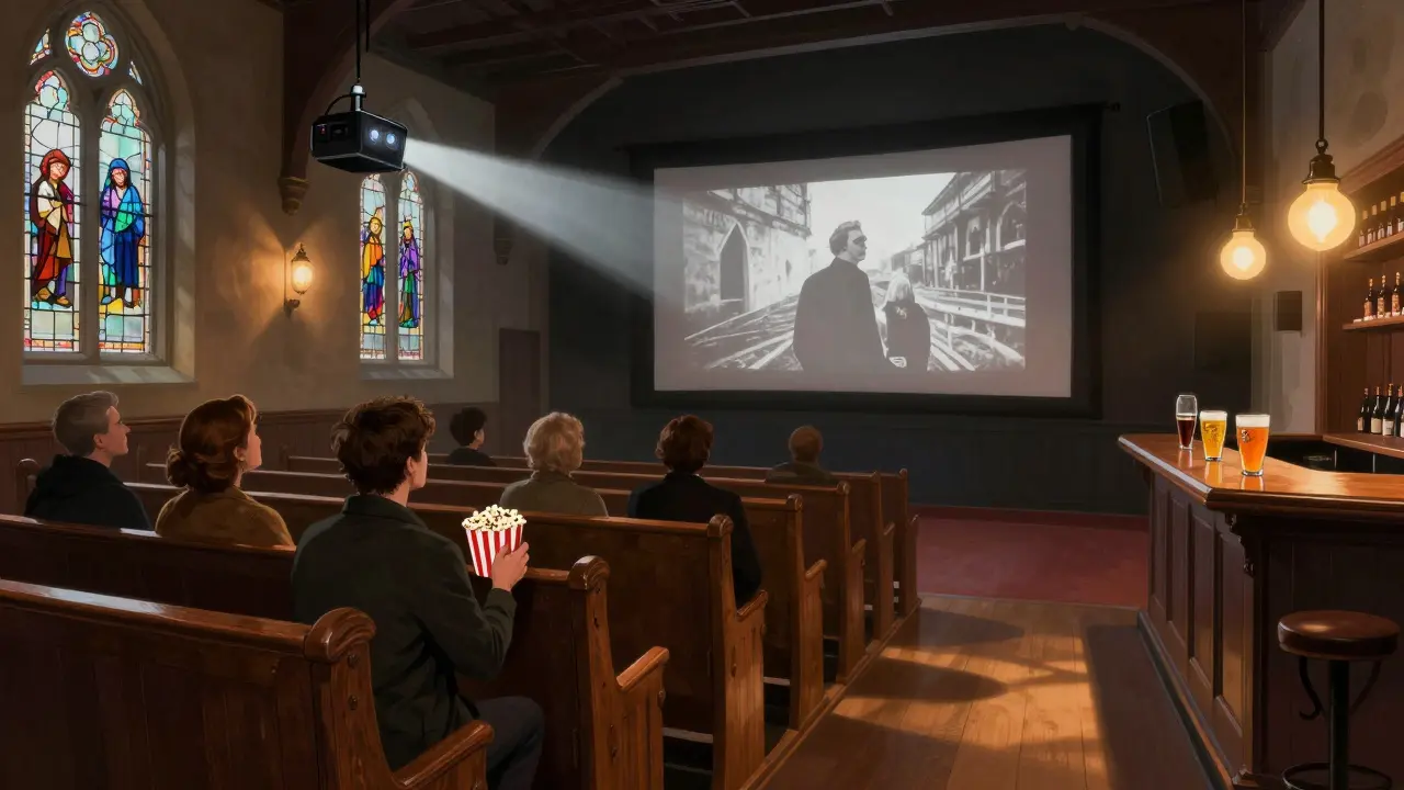 Quiet audience watching a black-and-white film in a converted chapel cinema with wooden pews and stained-glass light patterns.